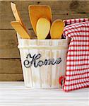 Wooden kitchen utensils on a wooden background