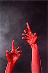 Creepy red devil hands with black nails, Halloween theme
