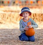 positive caucasian boy at the pumpkin patch