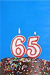 A number candle is lit in celebration of sixty five years.