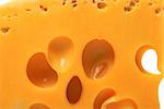 Slice of cheese with hole. Macro view.