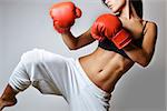 beautiful woman with the red boxing gloves, studio shot