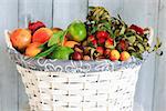 Photo of white basket with autumn fruits