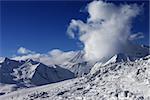 Snowdrift, ski slope and beautiful snowy mountains. Caucasus Mountains, Georgia. Ski resort Gudauri.