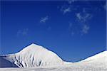 Ski slope with ropeway at sunny winter day. Caucasus Mountains. Georgia, ski resort Gudauri.