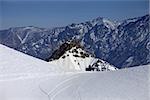 Trace from ski and snowboards on off-piste slope. Caucasus Mountains, Georgia, ski resort Gudauri.