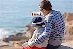 young father showing something to his son at the lookout