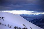 Off-piste slope and cloudy sky at sunset. Caucasus Mountains, Georgia. Ski resort Gudauri.
