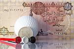 Money and golf equipments in Egyptian national colours