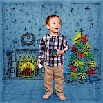 Cute baby in Christmas, standing with toys in his hands