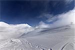 Ski slope with snowmobile trail. Georgia, ski resort Gudauri. Caucasus Mountains. Wide-angle view.