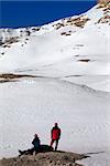Two hikers on halt in snow mountains. Turkey, Central Taurus Mountains, Aladaglar (Anti-Taurus), plateau Edigel (Yedi Goller).