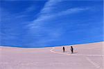 Two hikers on sunrise snowy plateau. Turkey, Central Taurus Mountains, Aladaglar (Anti-Taurus) plateau Edigel (Yedi Goller)