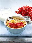 healthy breakfast granola corn with red currant (in blue bowl)