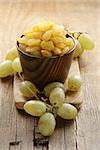 dried white grapes (raisins) on a wooden table