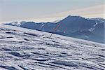 Ski slope with trace from ski and snowboards at sun day. Georgia, ski resort Gudauri. Caucasus Mountains.