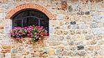 Pienza, Tuscany region, Italy. Old window with flowers