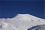 Off-piste slope with traces of skis at nice sunny day. Caucasus Mountains, Georgia, ski resort Gudauri.