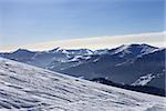 Ski slope with trace of ski, snowboards and mountains in haze. Georgia, Caucasus Mountains. Ski resort Gudauri.