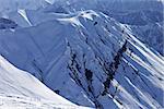 View from ski slope on snowy rocks. Caucasus Mountains, Georgia, ski resort Gudauri.