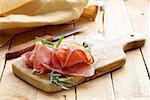 parma ham (jamon) sliced ??on a wooden board