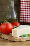 piece of natural parmesan cheese on a wooden board