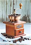 Vintage wooden coffee grinder full of roasted coffee beans