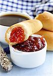 strawberry jam and bread rolls with a cup of coffee for breakfast