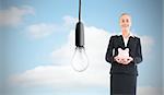 Composite image of blonde businesswoman holding pink piggy bank