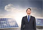 Composite image of solar panels standing on floorboards in the cloudy blue sky