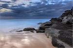 Tamarama Beach south side rocks on a dramatic, moody,  windy overcast morning