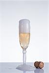 Elegant champagne glass and cork, New Year theme, studio shot on grey background