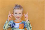cute positive little boy showing his fingers