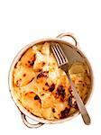 close up of a bowl of potato gratin isolated