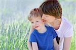 happy family of mother and son at blooming lavender field