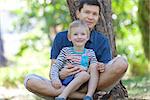 happy family of father and son sitting in the park