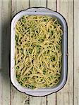 close up of a tray of rustic green pea spaghetti