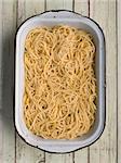close up of a tray of rustic spaghetti pasta noodles