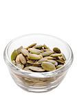 close up of a bowl of pumpkin seeds isolated