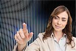 Composite image of businesswoman touching invisible screen