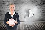 Composite image of blonde businesswoman holding pink piggy bank