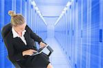 Composite image of blonde businesswoman sitting on swivel chair with tablet