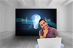 Composite image of thinking man sitting on floor using laptop and smiling