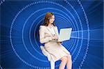 Composite image of smiling businesswoman sitting and using laptop