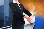 Composite image of blonde businesswoman holding piggy bank