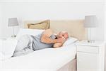 Mature man sleeping peacefully in bed at home