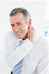 Mature man suffering from neck pain over white background