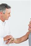 Male doctor examining a patients hand