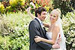 Romantic happy newlyweds embracing each other in the countryside