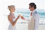 Newlyweds toasting with champagne at the beach